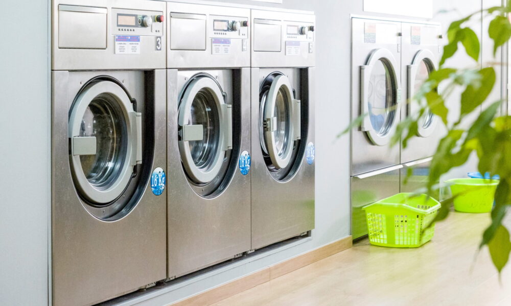 Public,Laundry,With,Modern,,Silver,Washing,Machines,In,A,Row